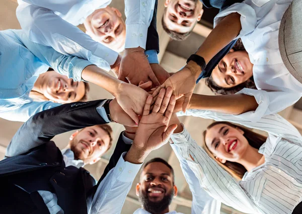 Home Stock Photo Team Standing In Circle Holding Hands During Meeting In Office